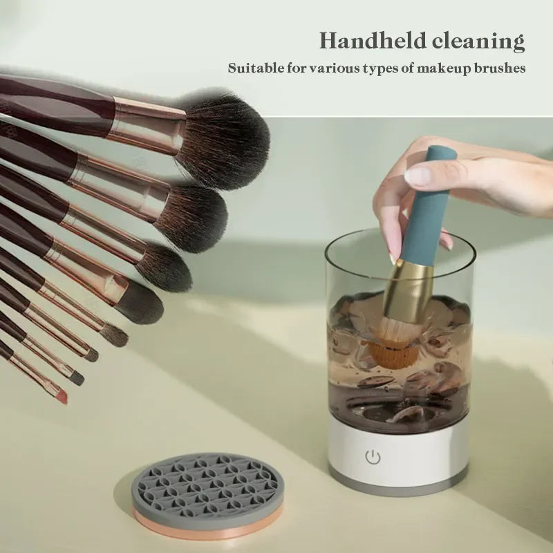 A person uses the Unik Store Automatic Electric Makeup Brush Cleaner, swirling a brush in water as sonic vibrations clean it. Several brushes are shown on the left. Text: Handheld cleaning. Suitable for various makeup brush types.
