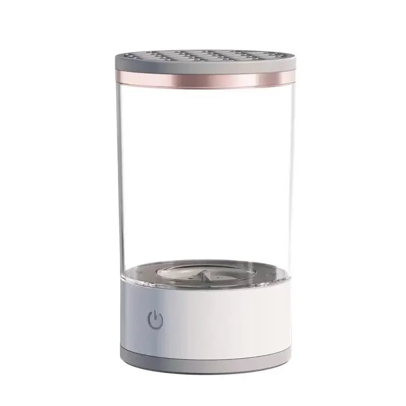 The Unik Store Automatic Electric Makeup Brush Cleaner features a modern, cylindrical design with a transparent body, metal top, and white base with power button, offering advanced sonic vibration cleaning for easy brush care.